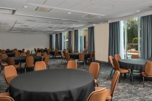 a conference room with tables and chairs and windows at Hampton Inn Austin Oak Hill in Austin +41 photos