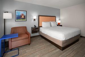 a hotel room with a bed and a chair at Hampton Inn Dover in Dover +21 photos