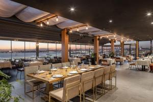 a dining room with a long table and chairs at DoubleTree By Hilton Istanbul - Moda in Istanbul