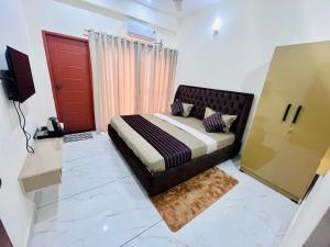 a bedroom with a bed and a red door at Selfie Residency in Mysore