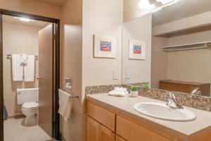 a bathroom with a sink and a toilet and a mirror at Wapato Point Resort in Manson +284 photos