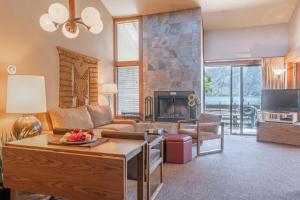 a living room with a couch and a fireplace at Wapato Point Resort in Manson