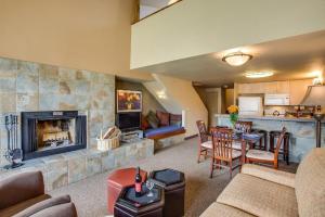 a living room with a fireplace and a dining room at Wapato Point Resort in Manson
