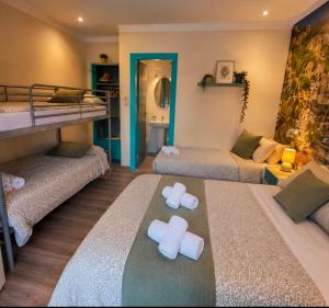 a room with two bunk beds and a bathroom at Emporda Llanca Guesthouse in Llança