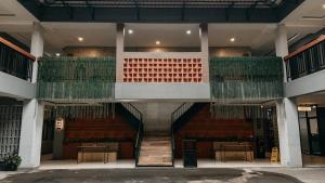 a large building with a staircase and green plants at Asthaloka Bed & Chill Pasteur in Bandung