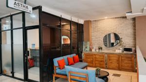 a living room with two chairs and a table at Asthaloka Bed & Chill Pasteur in Bandung