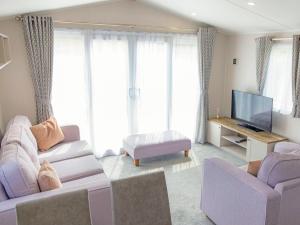 a living room with two couches and a flat screen tv at Nova - Ukc9932 in Aston