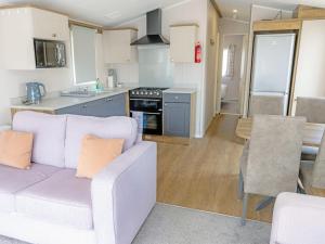 a living room with a couch and a kitchen at Nova - Ukc9932 in Aston