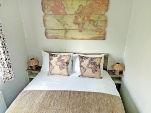a bedroom with a bed with a map on the wall at Nova - Ukc9932 in Aston +2 photos