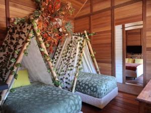 two hammocks in a room with a bedroom at Bleu Verde, The Self Healing Hotel & Retreat in Gili Trawangan