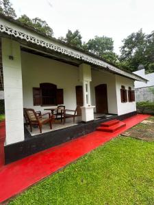 a house with a red carpet in front of it at La Olive Villa 