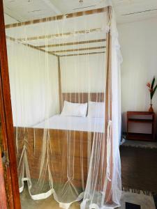 a bed with a mosquito net in a room at La Olive Villa 