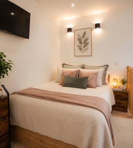 a bedroom with a large bed and a flat screen tv at Magic Disney 5mn Peaceful Home Garden Parking in Chessy