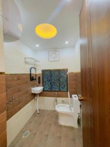 a bathroom with a sink and a tub and a toilet at Hotel Shankara Inn in Ayodhya