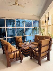 a living room with two couches and a table at Hotel Shankara Inn in Ayodhya