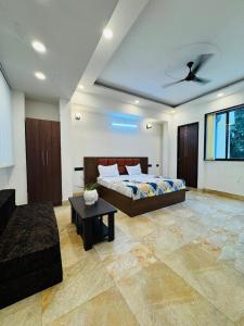 a bedroom with a bed and a ceiling fan at Hotel Shankara Inn in Ayodhya