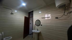 a bathroom with a sink and a mirror and a toilet at Bishoftu Bliss in Debre Zeyit