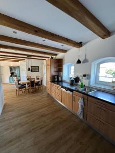 a kitchen with wooden cabinets and a dining room at Brokeloh - Hier bin ich zuhause ! in Landesbergen