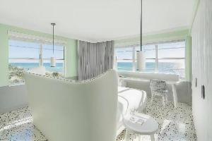a white living room with a table and chairs at COMO Metropolitan Miami Beach in Miami Beach