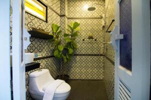 a bathroom with a toilet and a plant in it at Tanote Good View in Ko Tao +34 photos