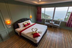 a bedroom with a bed with a bow on it at Tanote Good View in Ko Tao