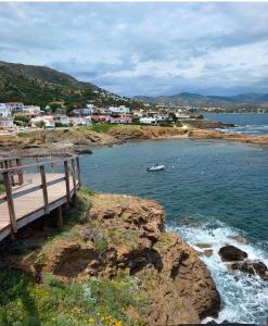 a boardwalk on the shore of a body of water at Emporda Llanca Guesthouse in Llança