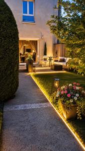 a garden path with lights in front of a house at Magic Disney 5mn Peaceful Home Garden Parking in Chessy