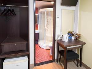 a bathroom with a toilet and a table and a sink at Metroplace Olympic in Hong Kong +95 photos