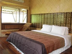 a bedroom with a large bed and a window at Phucome Resort in Campson +149 photos