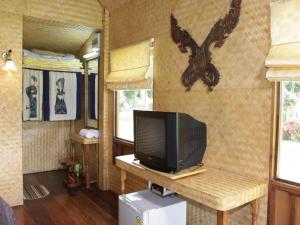 a tv sitting on a table in a tiny house at Phucome Resort in Campson