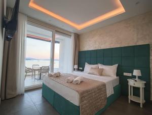 a bedroom with a large bed with towels on it at Apartments Soho in Trogir +105 photos
