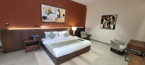 a hotel room with a bed and a desk at Kiwa Banquet & Hotel in Koba +17 photos