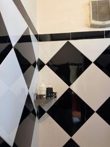 a bathroom with a black and white tiled wall at Nam Ou Breeze in Ban Ngoy-Nua +21 photos