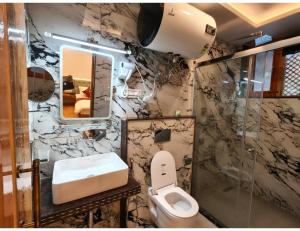 a bathroom with a toilet and a sink at Velour Pines Pahalgam in Pahalgām