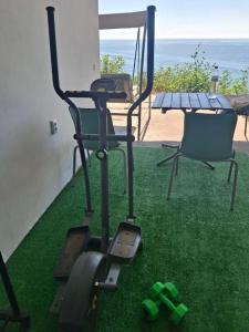 a exercise bike on the grass next to a table at Закоханий у море in Odesa +4 photos