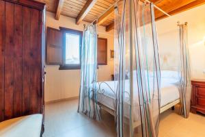 a bedroom with a four poster bed with mosquito nets at Casa PETRONILA in Lerma