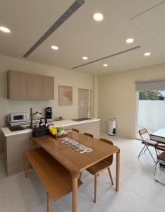 a kitchen with a wooden table in a room at 七之二民宿 in Hengchun South Gate
