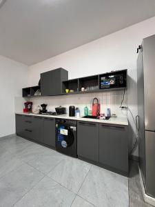 a kitchen with a stove and a refrigerator at Bon Hostel Kg in Bishkek