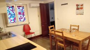 a kitchen with a wooden table and a dining room at Le Coccole in Catania
