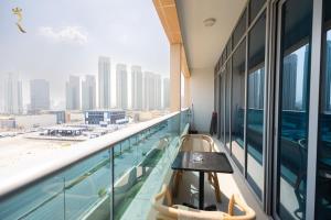 a balcony with a table and a view of the city at Pearl 1BR Al Reem - Serene Luxe Escape in Abu Dhabi