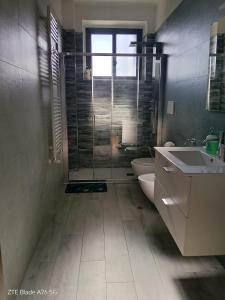 a bathroom with a shower and a toilet and a sink at Casa Alba in Taranto +11 photos
