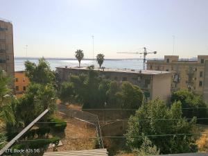 a view of a city with palm trees and buildings at Casa Alba in Taranto
