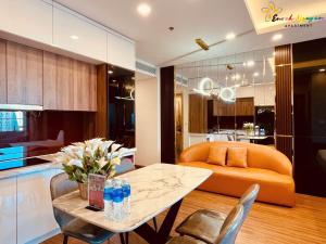 a living room with a table and a couch at FLC Quy Nhơn Sea Condotel in Quy Nhon