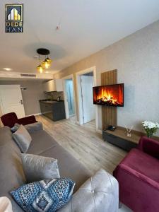a living room with a couch and a fireplace at Dedehan Hotel in Trabzon
