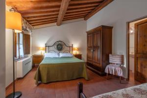 a bedroom with a bed and a chair in a room at Il Lebbio Agriresort in Montaione +229 photos