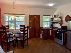 a kitchen with a table and chairs in a kitchen at Los Mangoes in Hopkins