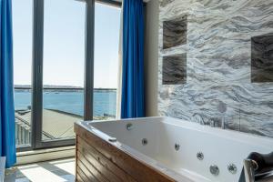 a bath tub in a bathroom with a view of the water at Elite World Homes Istanbul Bosphorus in Istanbul +103 photos