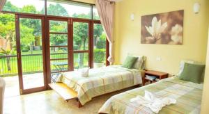 a bedroom with two beds and a balcony at Doembang Villa in Ban Tha Pong +286 photos