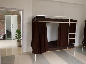 a bunk bed in a room with a mirror at Naga Hills Backpacker Hostel in Kohīma