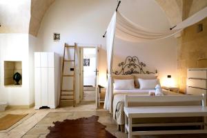 a bedroom with a bed and a room with a ladder at Corte Dei Francesi in Maglie +25 photos